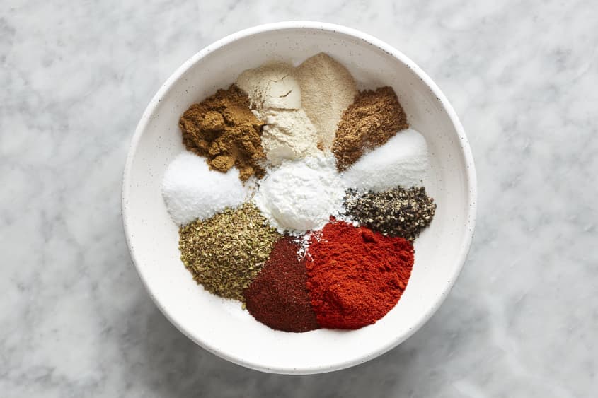 Spices added into sections in one bowl.