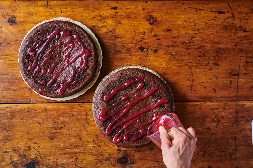adding cherry syrup to the trimmed cakes