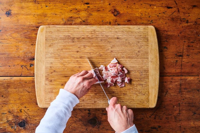 Chopping bacon on cutting board