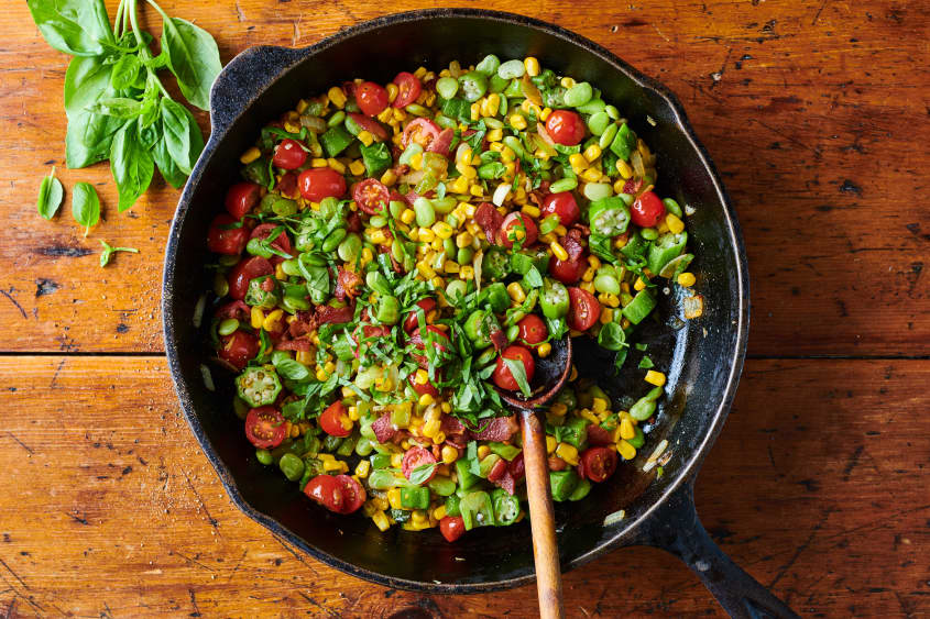 succotash in cast iron topped with chopped basil