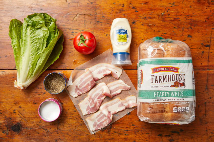 BLT ingredient line up right to left: Mayonnaise, Farmhouse white bread, bacon, salt and pepper, Romaine lettuce