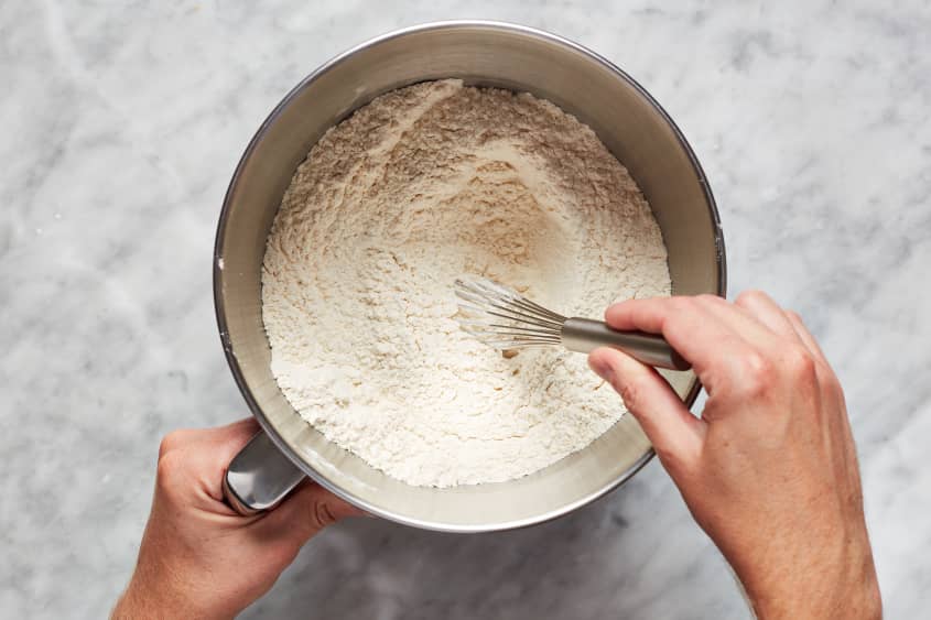 Dry ingredients are whisked together in a large bowl.