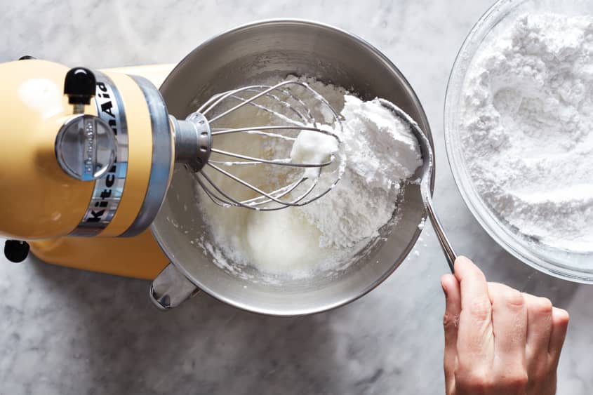 Confectioners sugar being added to mixing bowl.