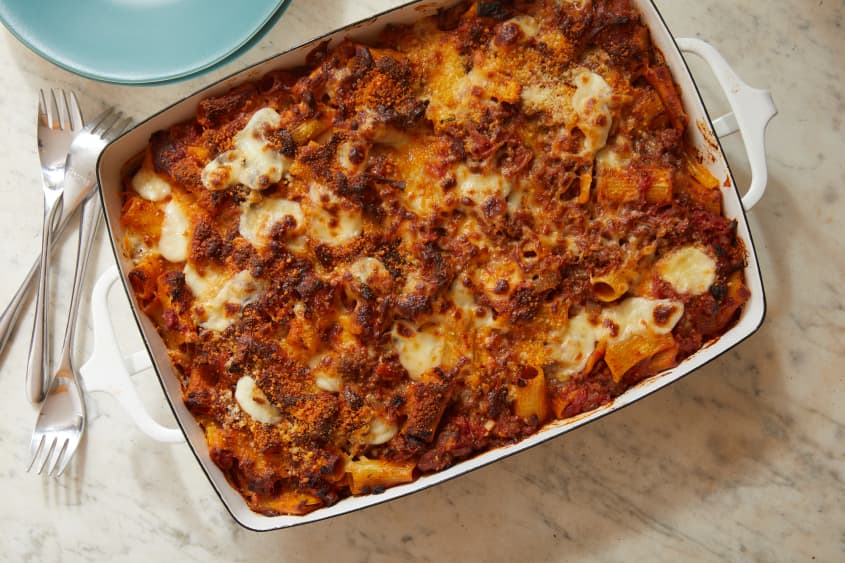 Cheesy baked rigatoni with beef on countertop.
