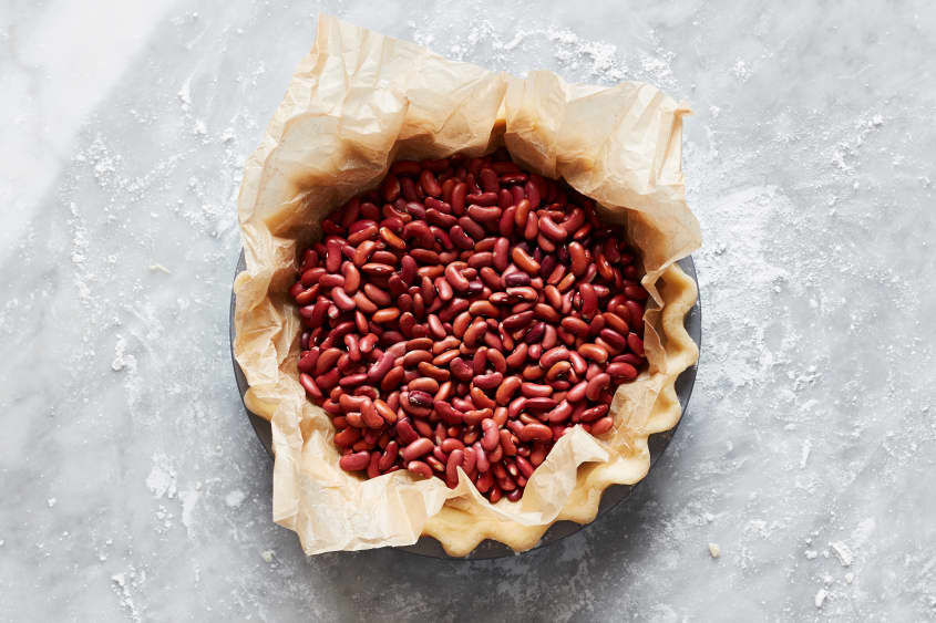 Pie crust filled with beans for blind baking.