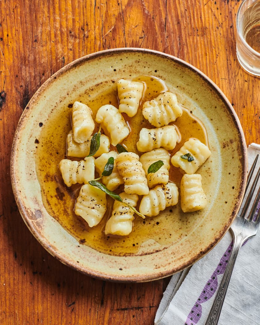 Gnocchi plated with brown butter and sage.