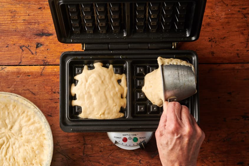 Batter being poured into waffle maker.