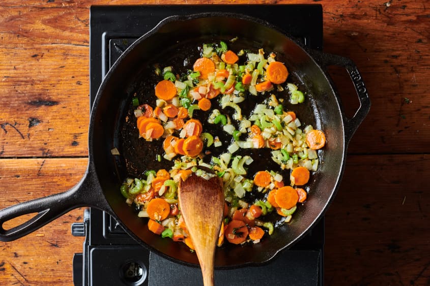 Carrots, celery and onion cooking in skillet.
