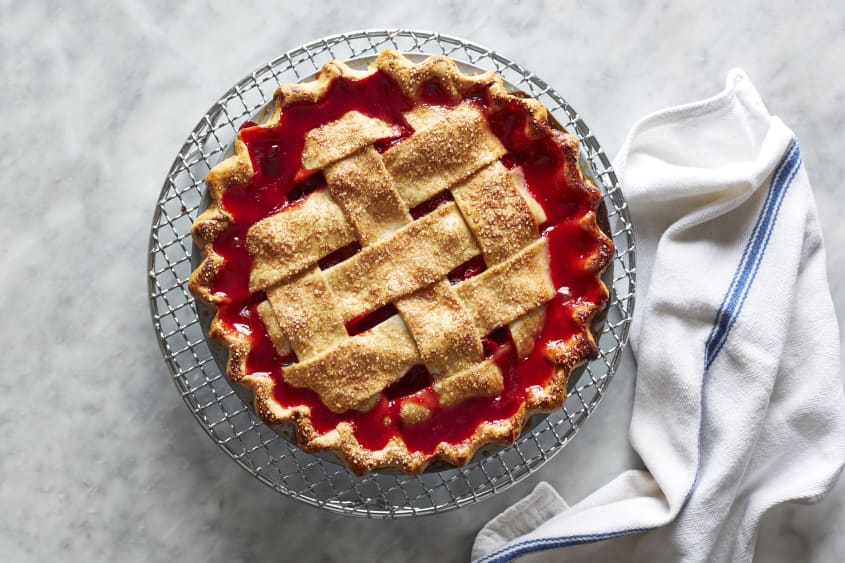 Baked strawberry rhubarb pie on a cooling rack