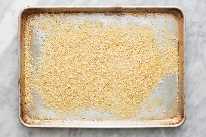 bread crumbs are spread out on a sheet pan