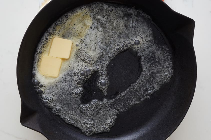 Butter is melted in the skillet.