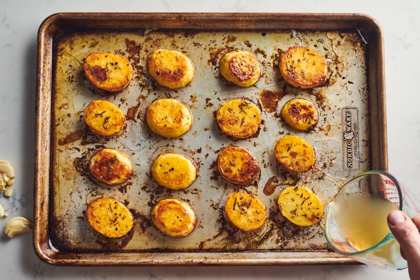 someone is pouring oil on the potatoes