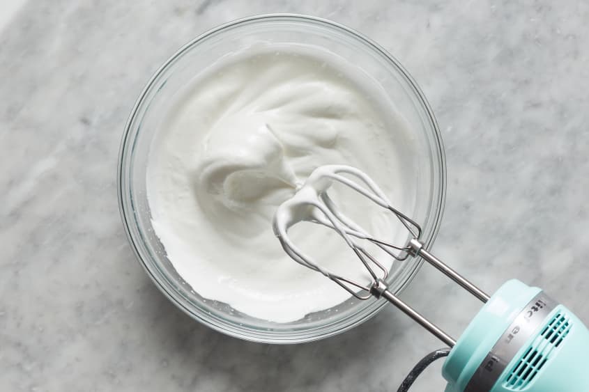hand mixer wtih cream in a bowl