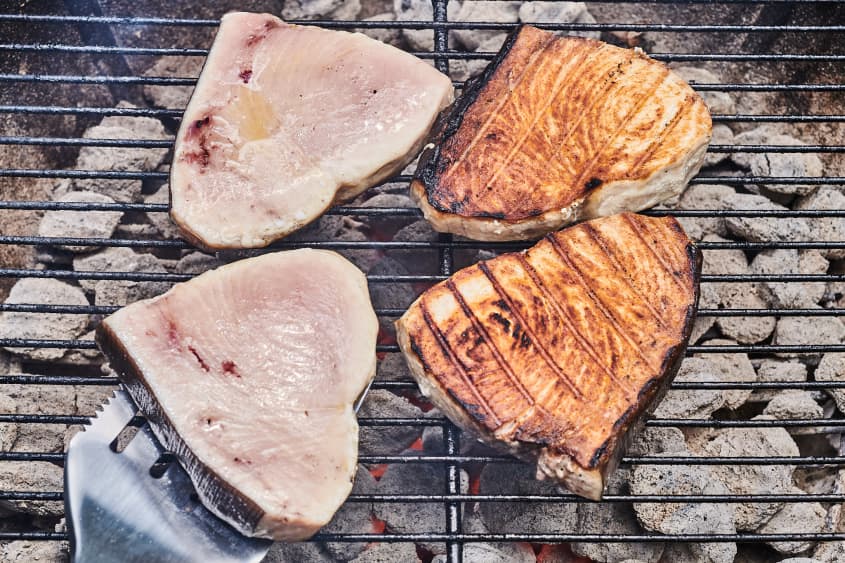 swordfish being flipped on the grill