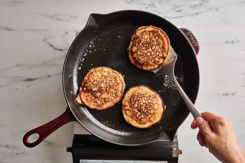 pancakes cooking on cast iron skillet
