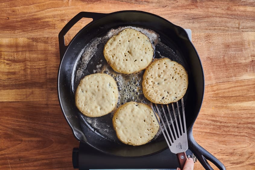pancakes on cast iron pan ready to be flipped