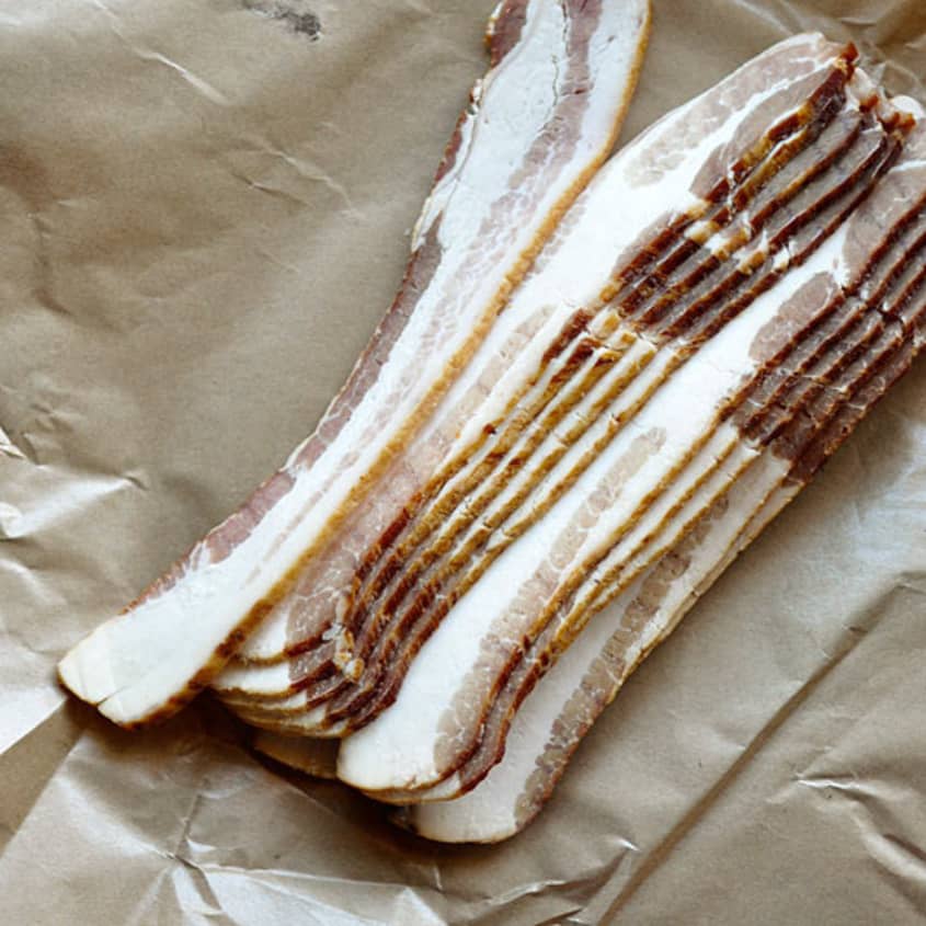 Slices of bacon on a brown wrapping paper