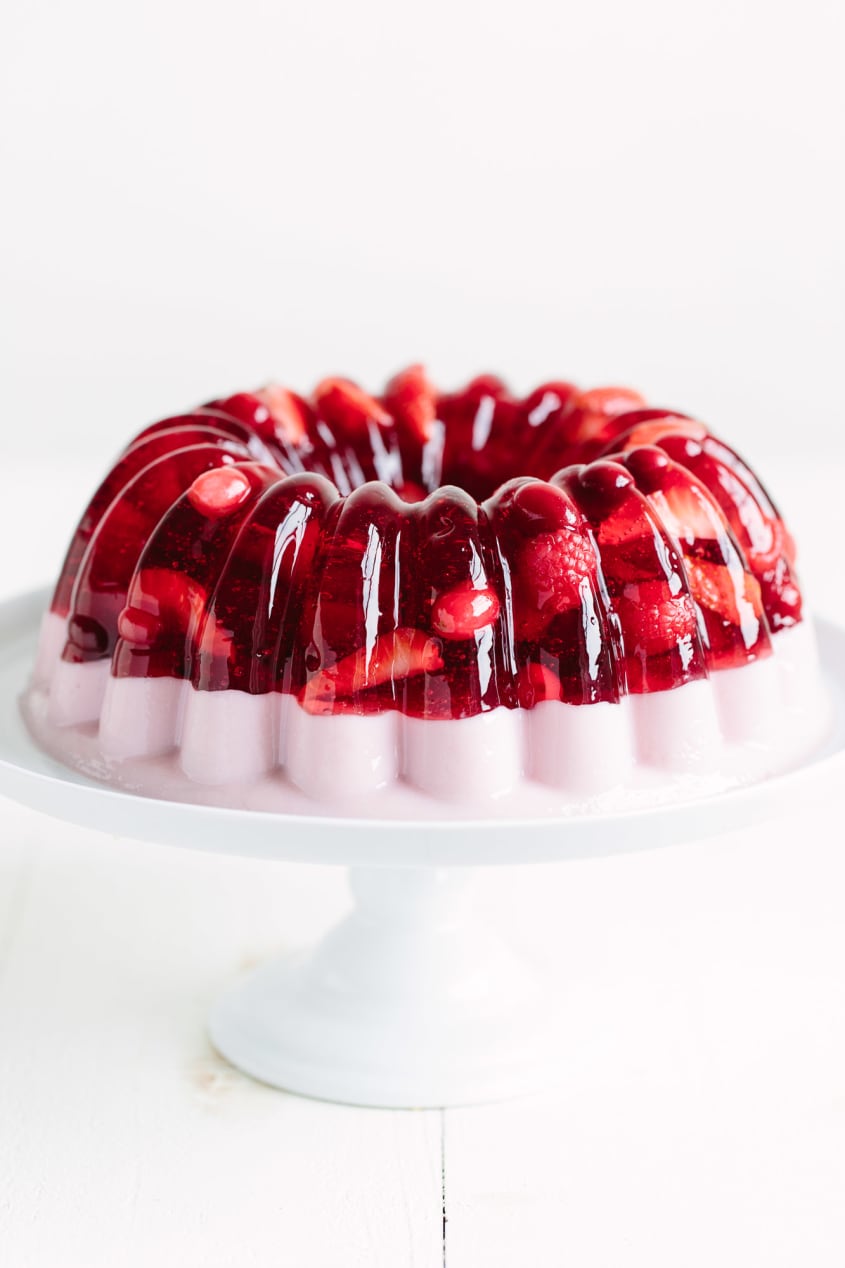 A two-layer jello mold with one gelatin mixture on a cake stand
