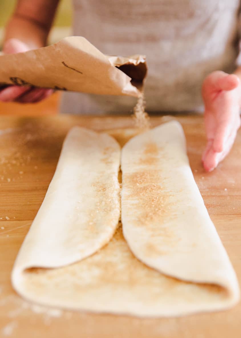 Course-grained sugar is spread on the sides of the folded dough