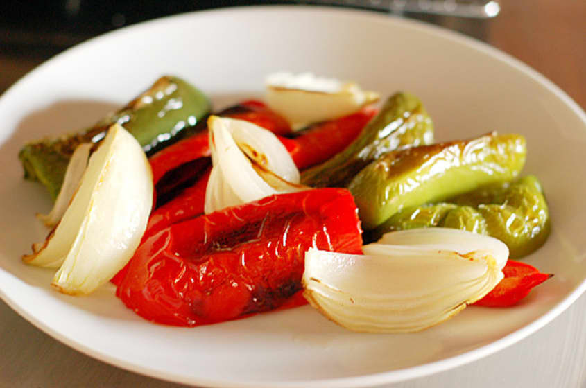 A medley of roasted bell peppers and onions on a plate