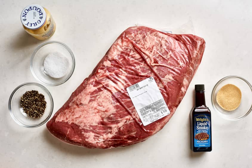 Ingredients for Texas-style beef brisket, from left to right: Dijon mustard, salt, course ground pepper, brisket, Wright's liquid smoke, and garlic powder