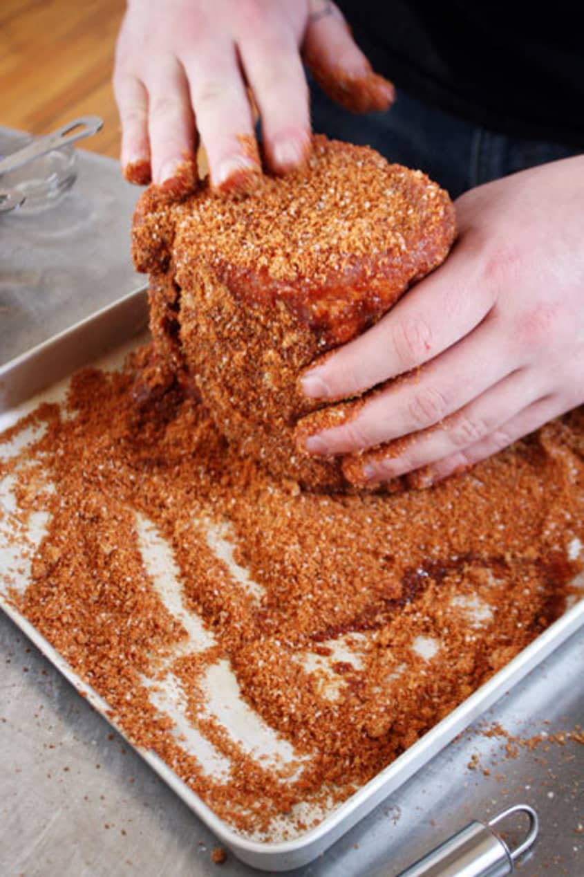 Dry rub seasoning is rubbed onto the meat