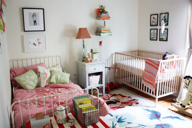 twin bed and crib in small room