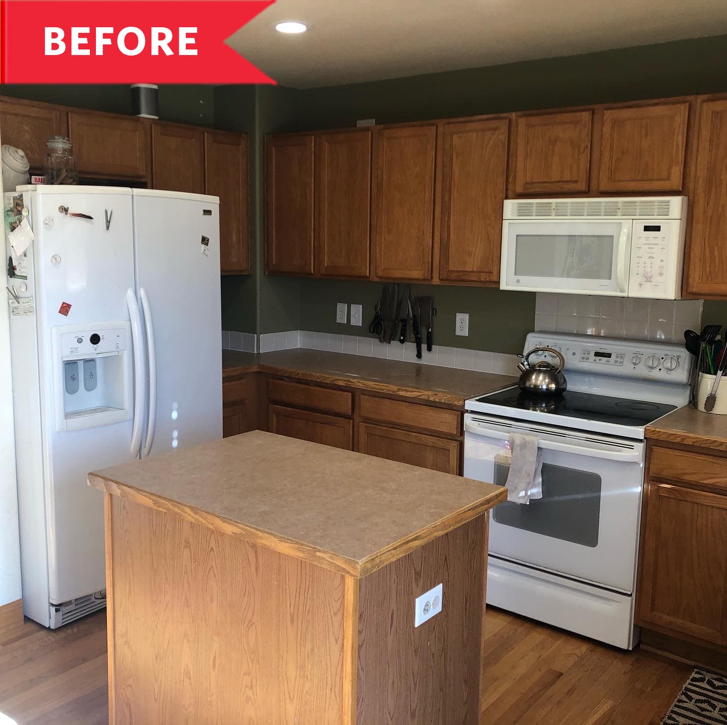 Before: Kitchen with brown cabinets, white appliances, and wooden island in center