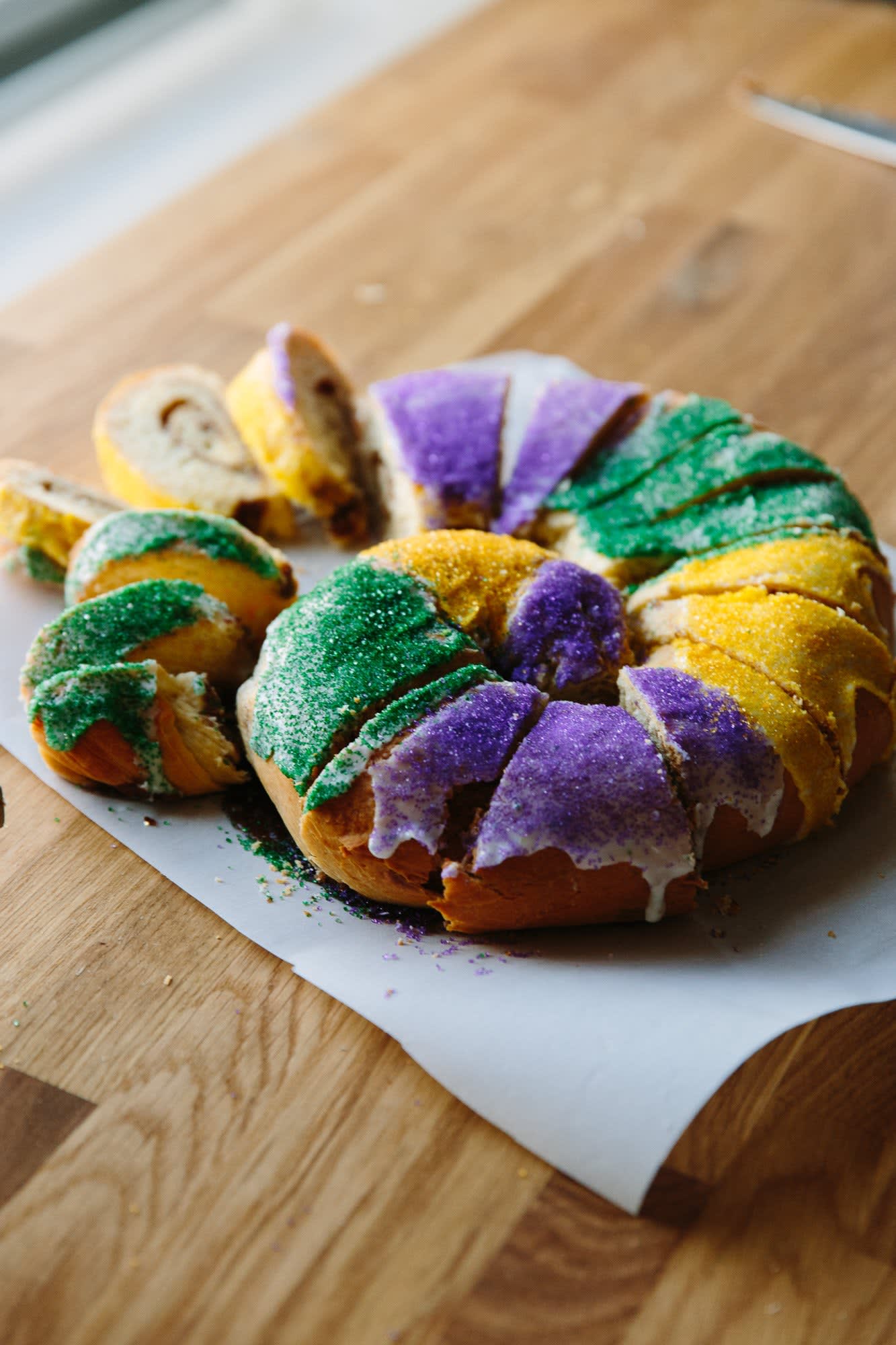 King cake: Oval pastry for Mardi Gras, filled, iced, and sprinkled.