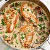 Chicken breasts and mushrooms in creamy parmesan garlic sauce in a saucepan