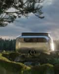 Silver SUV towing a sleek, modern trailer in a forest setting at sunset.