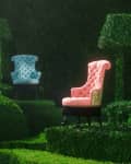 Three tufted chairs in pink, blue, and floral patterns set among manicured green hedges and topiary.
