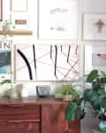 A TV disguised as an abstract art print in a gallery wall