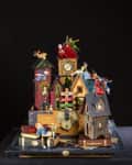 Whimsical Peter Pan-themed diorama with colorful houses, clock tower, and characters in playful poses.