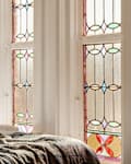 Stained glass window in stylish bedroom.