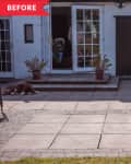 Patio with potted plants, a red tricycle, and a dog lying near open French doors.