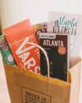 Gift bag with Atlanta maps, brochures, and a personalized label for Taryn & J.R.'s event on October 11, 2014.