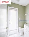 Small bathroom with green walls, white vanity, large mirror, and shower curtain.