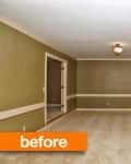 Empty living room with green walls, stone fireplace, beige carpet, and a ceiling light fixture.