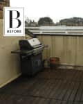 Rooftop terrace with wooden decking, a gas grill, and cityscape view.