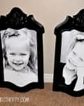Two black ornate frames with black-and-white portraits of smiling young girls, placed on a carpeted floor.