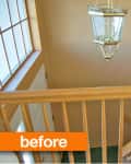 Staircase with wooden railing, beige walls, large window, and hanging light fixture. Orange "before" label in corner.