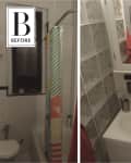 Narrow bathroom with glass block wall, colorful shower curtain, and small sink with mirror cabinet.