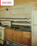 Dated kitchen with wooden cabinets, old stove, and fridge, missing backsplash tiles.