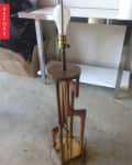 Wooden floor lamp with abstract design and exposed bulb, labeled "Before."