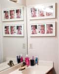 Bathroom with baby photo collage, sink with toiletries, and shower curtain.