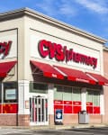 CVS Pharmacy storefront with red awnings, large logo, and drive-thru pharmacy signage.