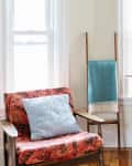 Chair, dresser, and ladder with blankets on it