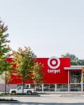 Target store exterior with red logo, surrounded by trees and a parked white truck.