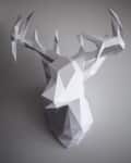 Geometric paper deer head sculpture with angular facets and antlers.